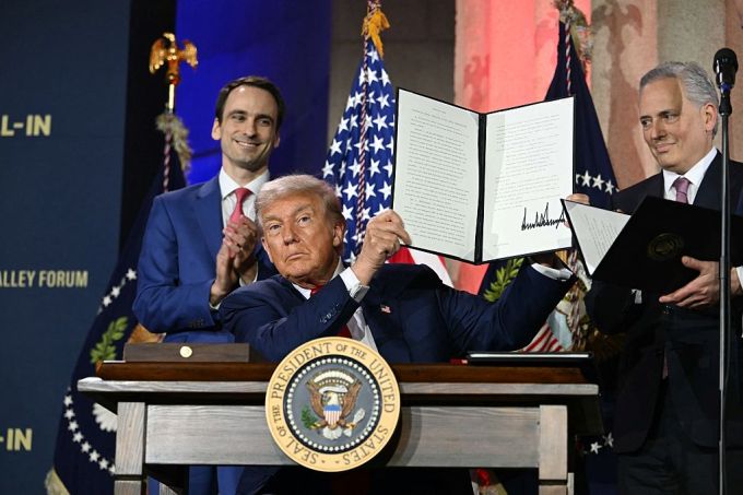 US President Donald Trump displays an executive order on artificial intelligence he signed at the "Winning the AI Race" AI Summit at the Andrew W.